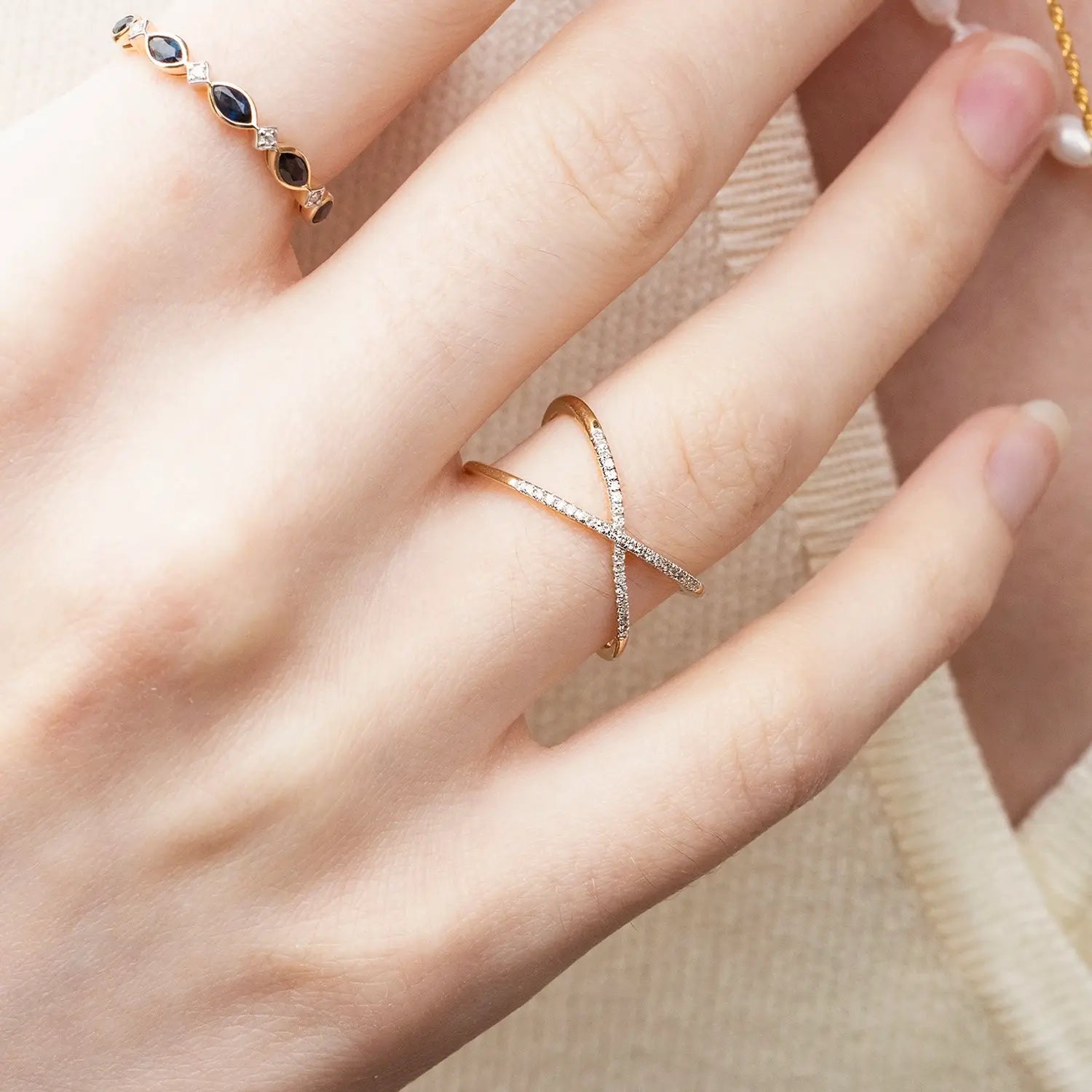 model wearing multi diamond cross solid gold ring