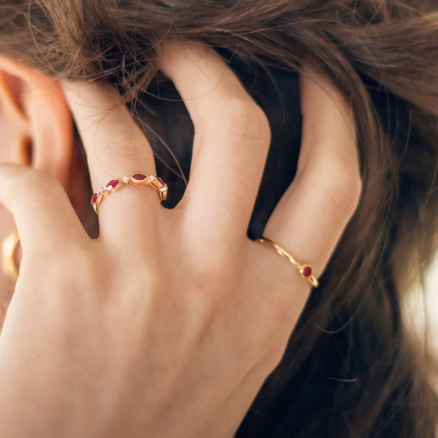 model wearing ruby and diamond gold ring, and ruby gold ring