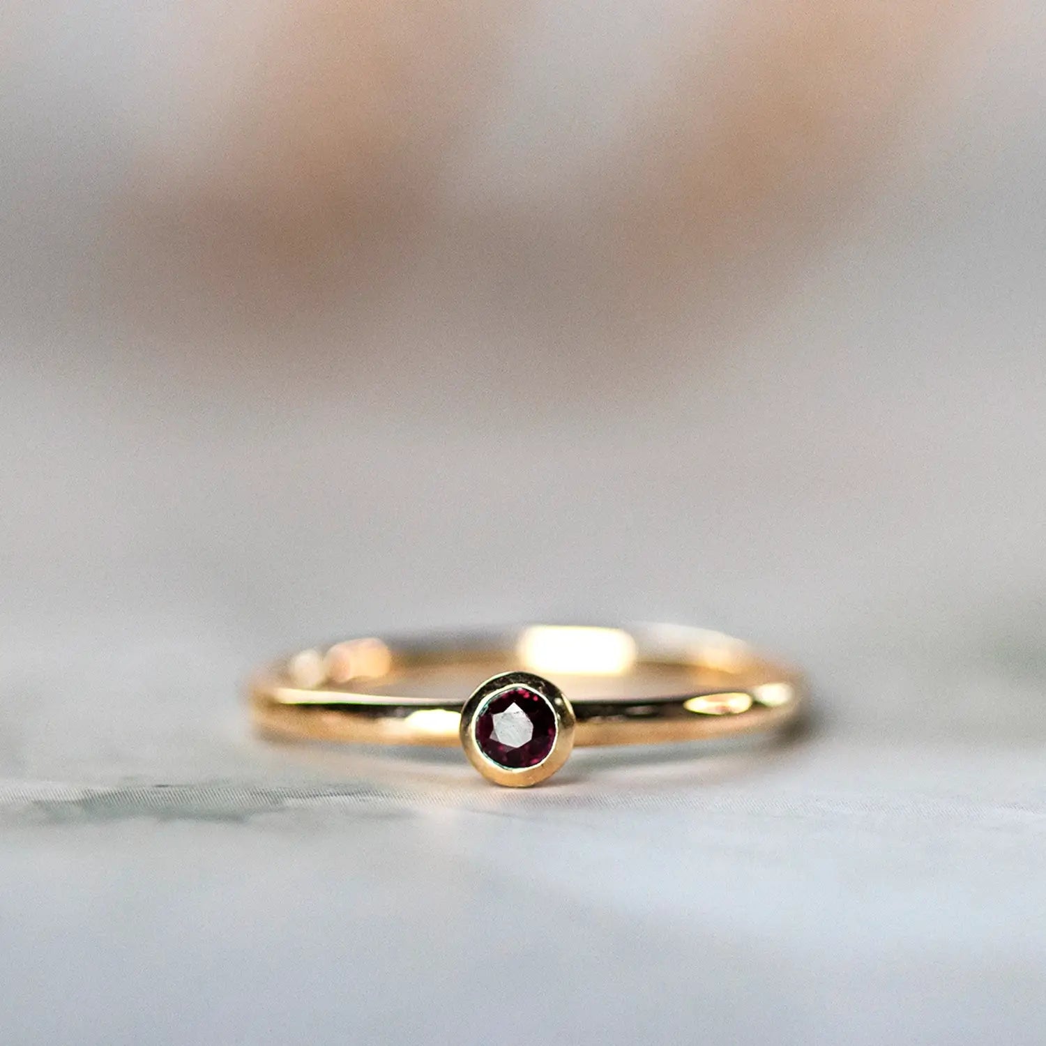 ruby gold ring with light reflection