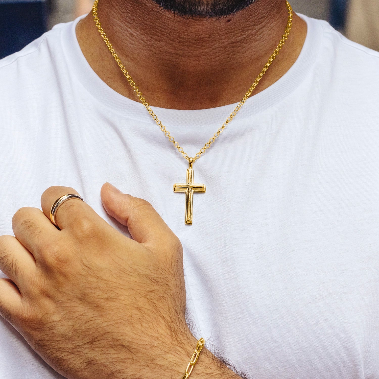 man in white t-shirt wearing large gold cross necklace, thick gold belcher chain, high polish finish, bevelled edges, religious Christian pendant for men and women, men's jewellery