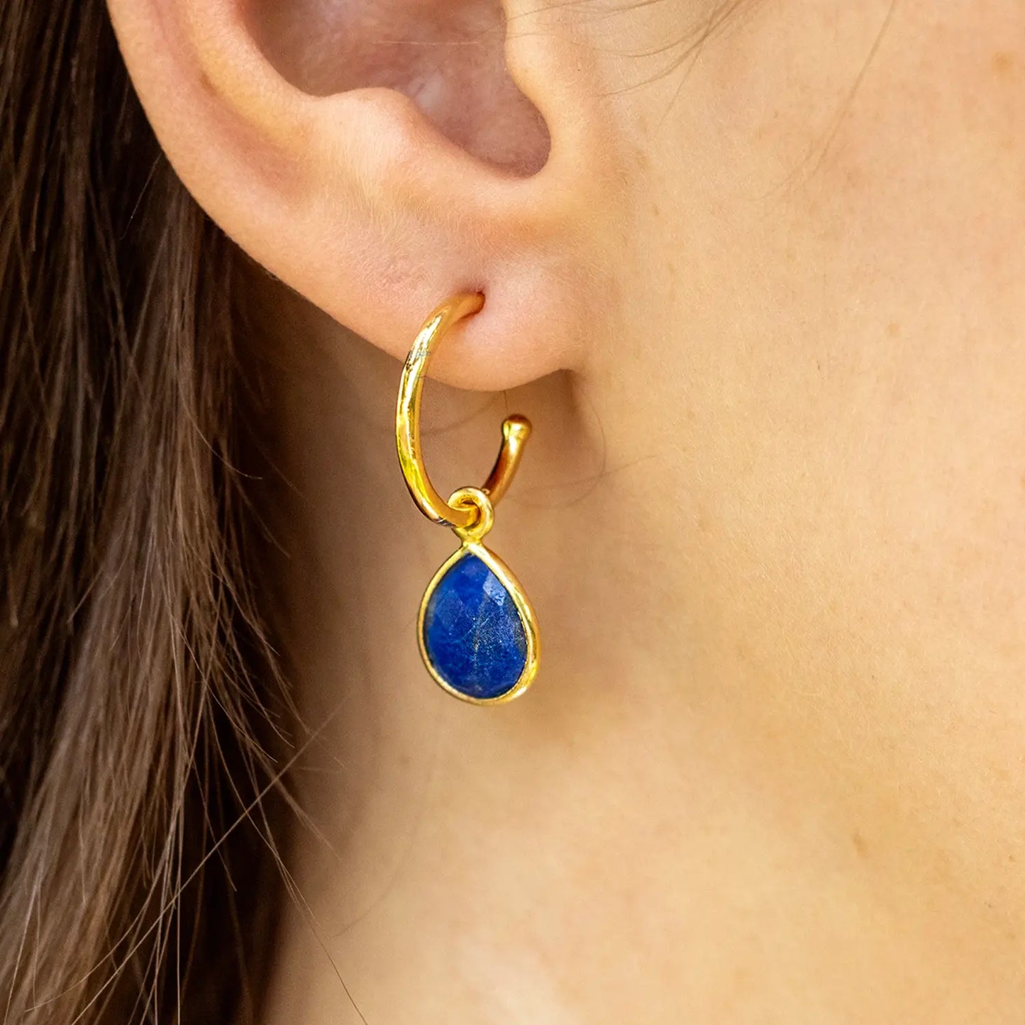 model wearing lapis lazuli gold drop hoop earrings