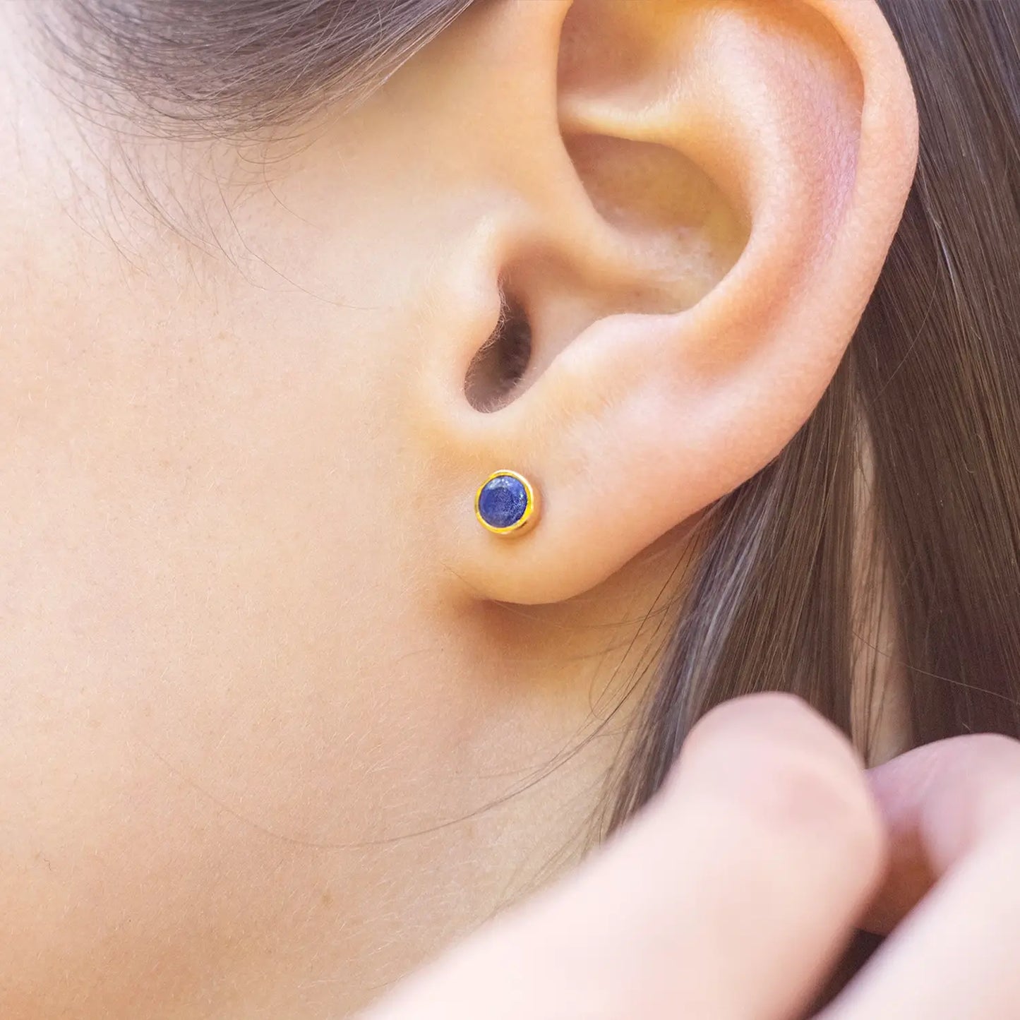 model wearing lapis lazuli gold stud earrings 